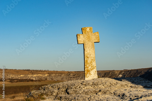 Tourist attraction in Orhei, Moldova. The Old Orhei Cross in front of the old stone carved church photo