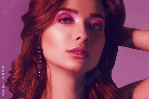 Wallpaper Mural Fashion portrait of young elegant girl in jewelry. Colored background, studio shot. Beautiful brunette woman. Girl posing in neon light. Woman with stylish hair and pink lips and cerly hair. Beauty. Torontodigital.ca