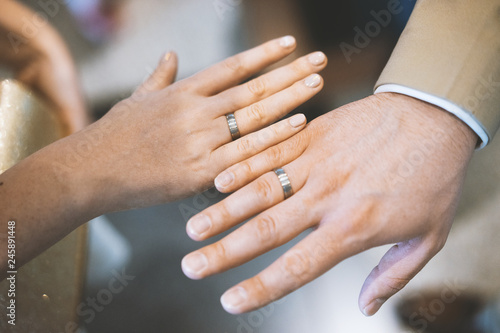 Fototapeta Naklejka Na Ścianę i Meble -  Young couple showing hands with wedding rings