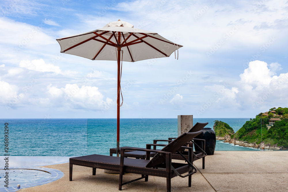 Beach chair in outdoor with swimming pool and sea view andaman sea