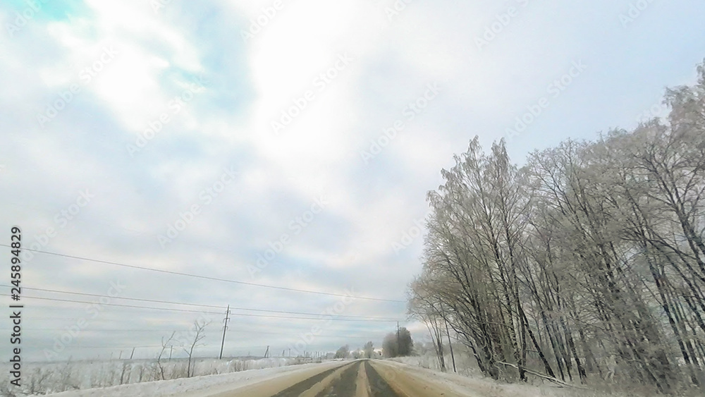 Country road in winter along the forest with white snow trees Country road in winter along the forest with white snow trees
