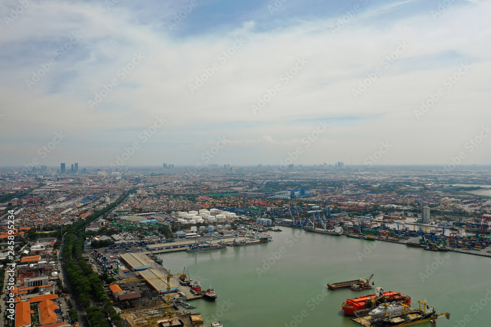 Fototapeta premium aerial view cargo and passenger seaport with ships and crane Tanjung Perak, surabaya, indonesia. docks for the repair and parking of ships, cargo port and container terminal. ship in industrial port