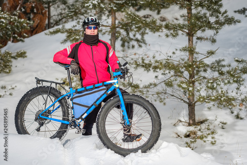 A young man riding fat bicycle in the winter. Fat tire bike. 
