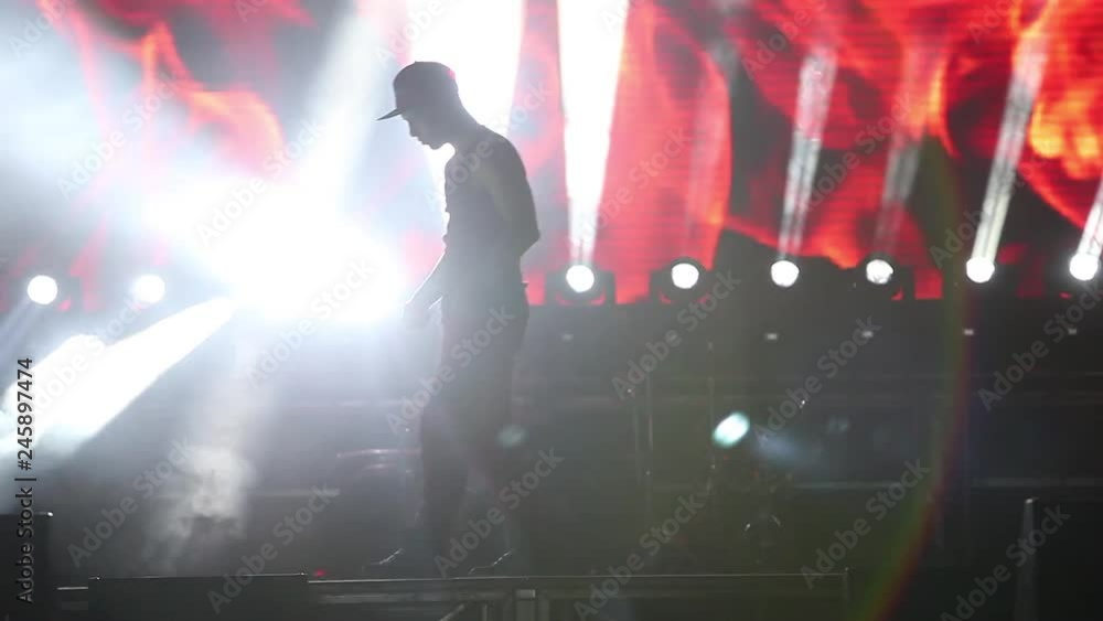 boy dancer on the nightclub scene. Silhouette of a man dancing in the spotlight boy dancer on the nightclub scene. Silhouette of a man dancing in the spotlight