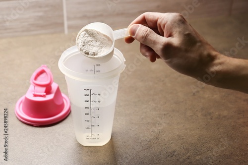 Preparation of protein drink. Food supplement after workout.