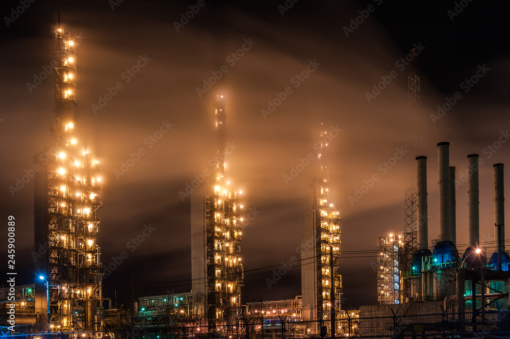 Chemical industry distillation towers detail at night. Petrochemical background. Long exposure at winter dusk.