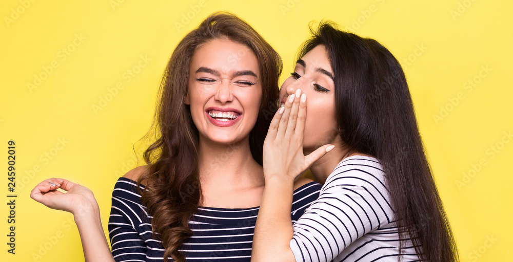 Two beautiful girls telling each other secret Two beautiful girls telling each other secret