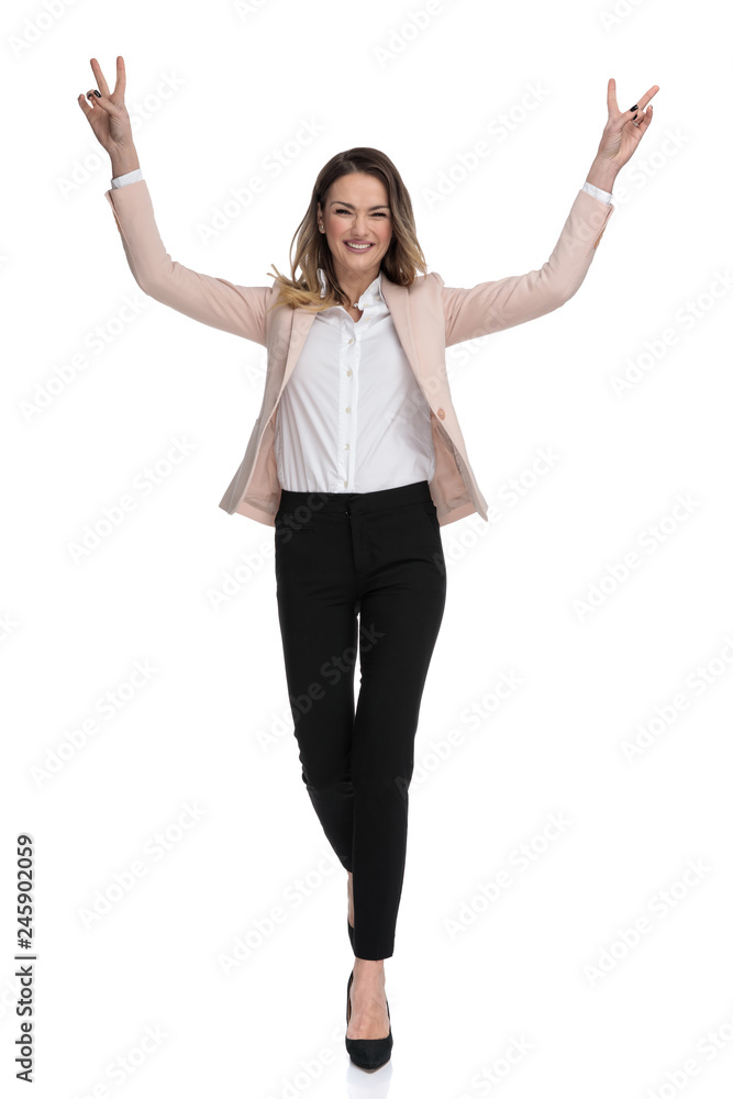 beautiful businesswoman walks and celebrates with hands in the air beautiful businesswoman walks and celebrates with hands in the air