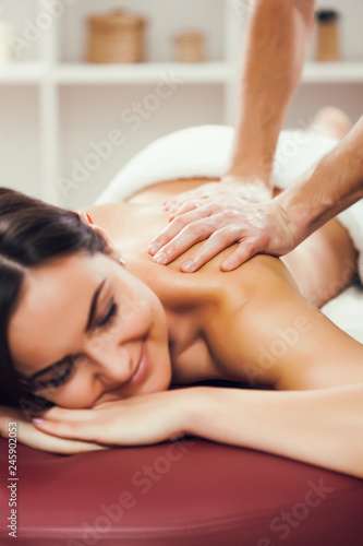 Young woman is enjoying massage on spa treatment. 