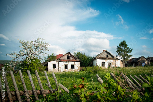 Wallpaper Mural Abandoned houses in the village against the blue sky, broken roofs and fences Torontodigital.ca