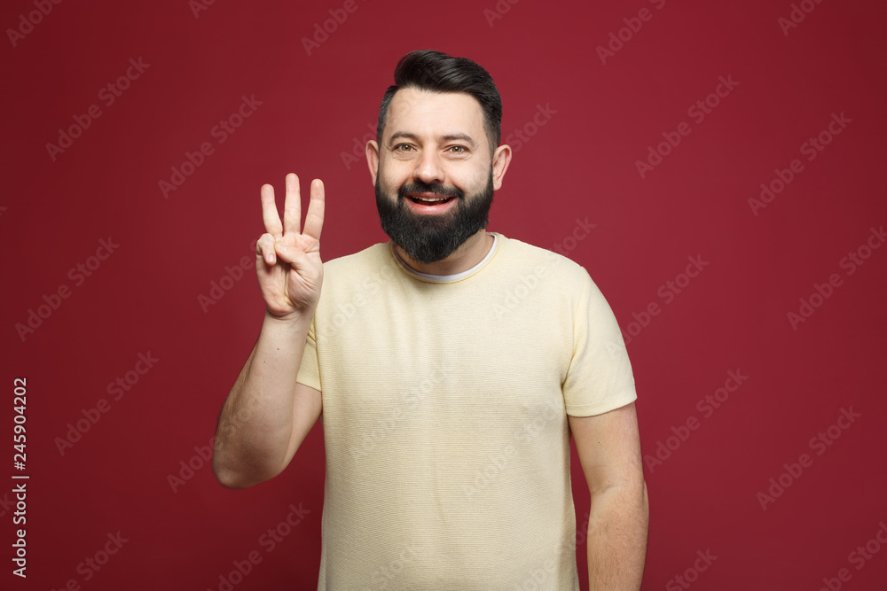 a young pretty cute brunette with a beard showing on her fingers three a young pretty cute brunette with a beard showing on her fingers three