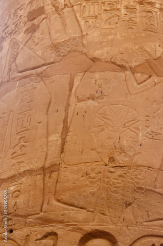 Ancient Egyptian fertility god Min carved on column in Great Hypostyle Hall in Karnak temple complex in Luxor, Egypt