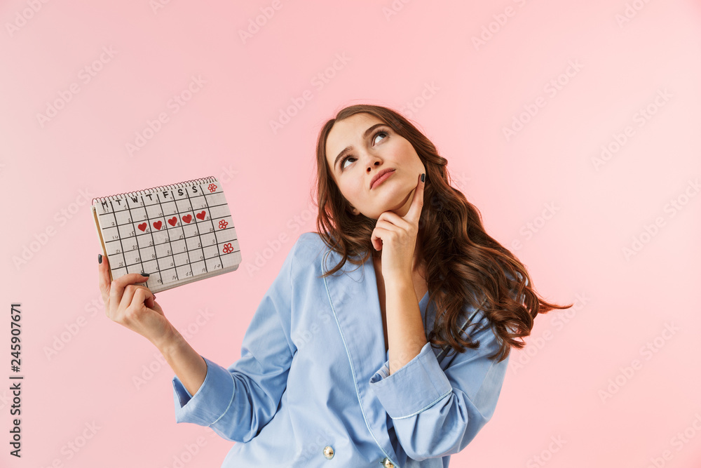 Beautiful young woman wearing pajamas standing