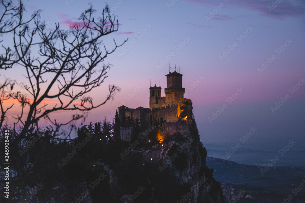 Obraz premium panoramic view of ancient medieval San Marino fortress on a winter sunset with few clouds