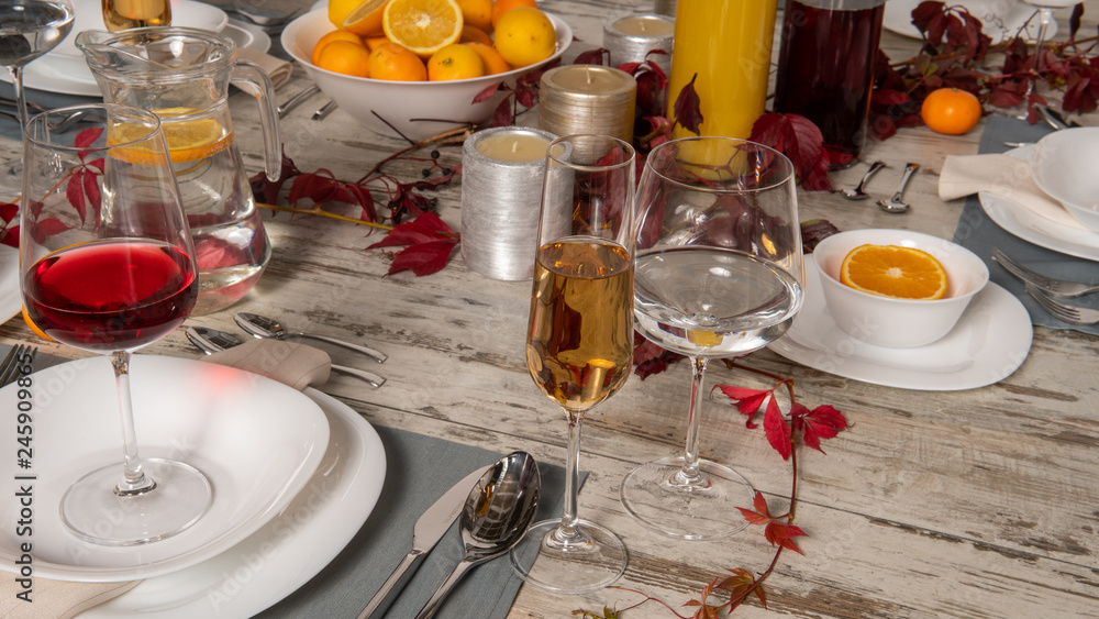 Rustic table setting with pink flowers and candle on light wooden table. Holidays decoration on Provence style. Romantic dinner. Overhead