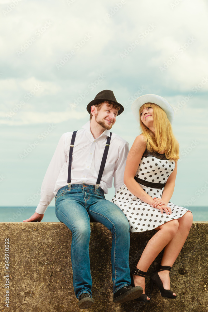 Loving couple retro style dating on sea coast Loving couple retro style dating on sea coast