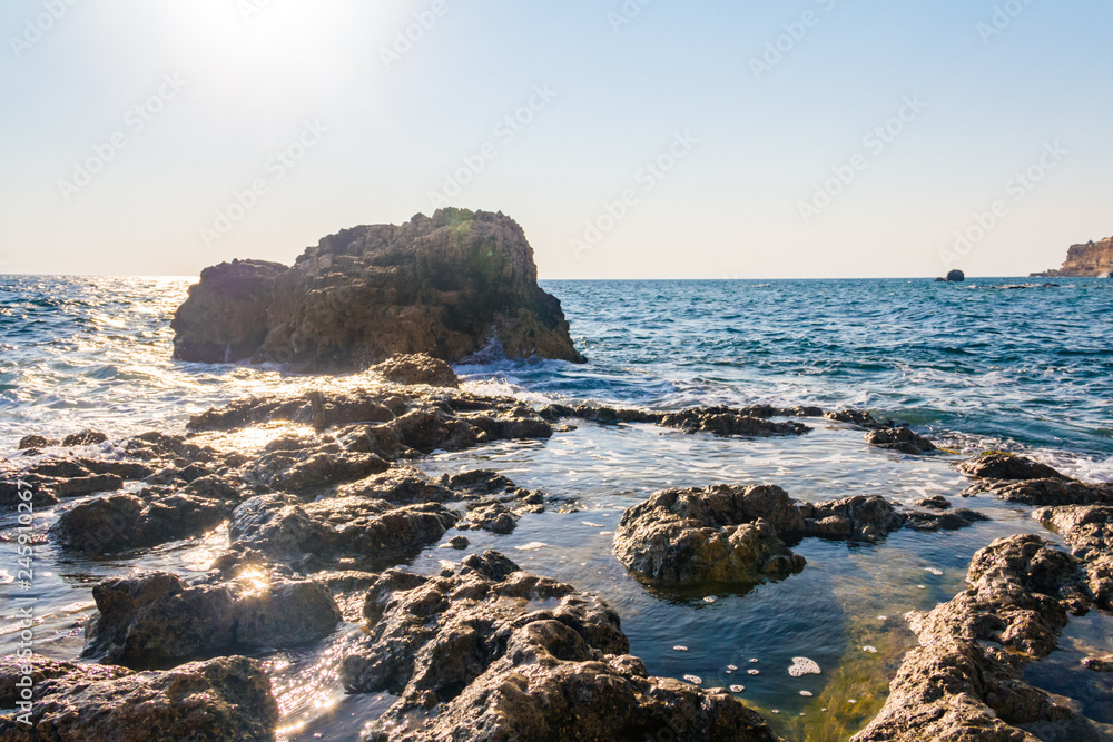 Landscape sea waves line impact rock on the beach. Stones at the beach with wave and nice blue sky. turquoise water Landscape sea waves line impact rock on the beach. Stones at the beach with wave and nice blue sky. turquoise water