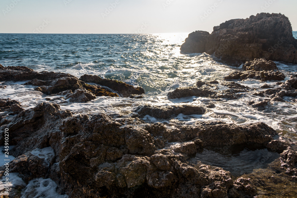 Landscape sea waves line impact rock on the beach. Stones at the beach with wave and nice blue sky. turquoise water Landscape sea waves line impact rock on the beach. Stones at the beach with wave and nice blue sky. turquoise water