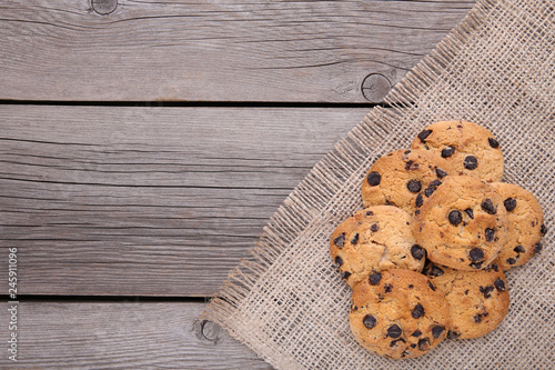 Chocolate cookies on grey sackcloth . Chocolate chip cookies shot