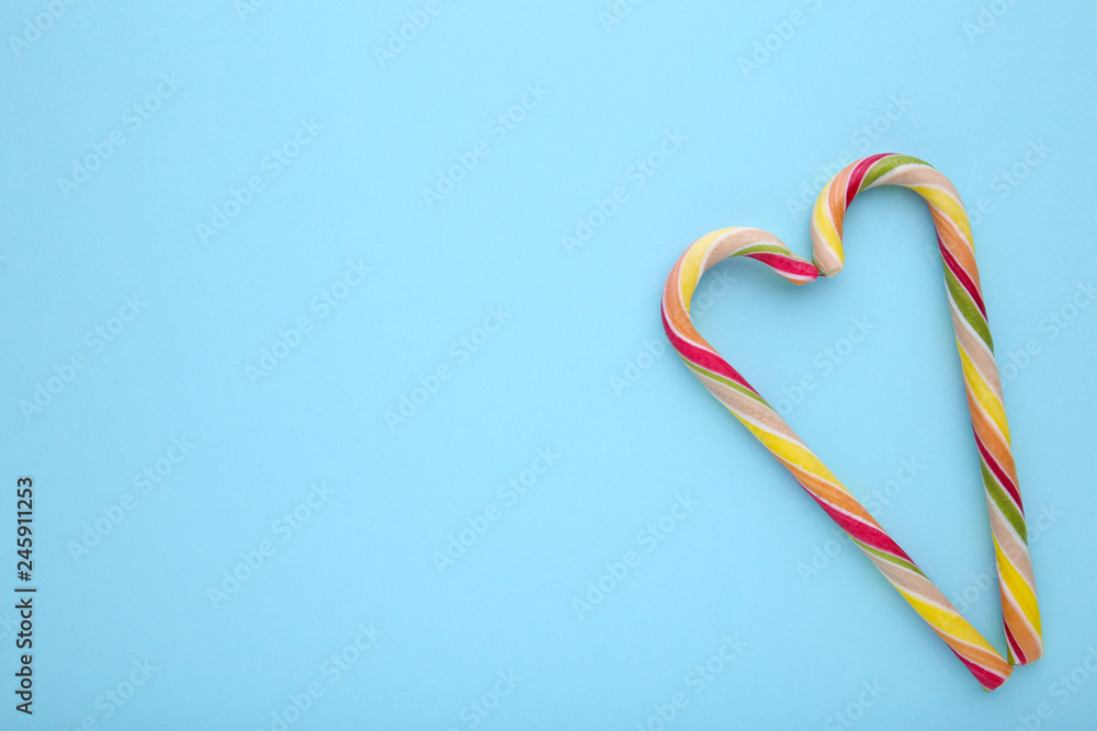 Fototapeta premium Colorful lollipops on blue background. sweet candy concept