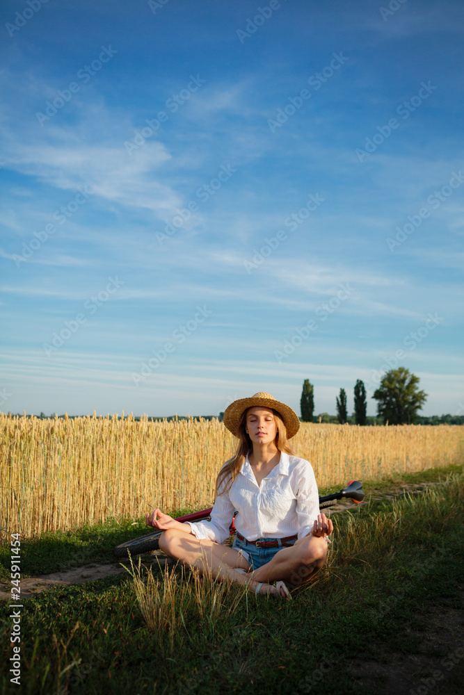 Girl in wheat field making yoga