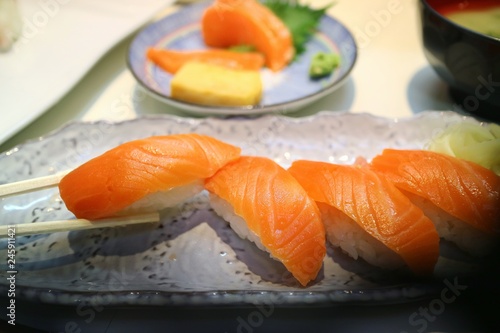 Selective focus of salmon nigiri sushi with chopsticks. Famous Japanese food. Food concept. 