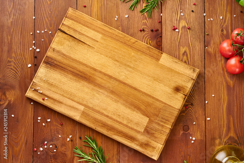 Wallpaper Mural Menu, recipe, mock up, banner. Food seasoning background. Spices, Herbs and wooden cutting board on brown dark wooden backdrop. Top view, copy space. Torontodigital.ca