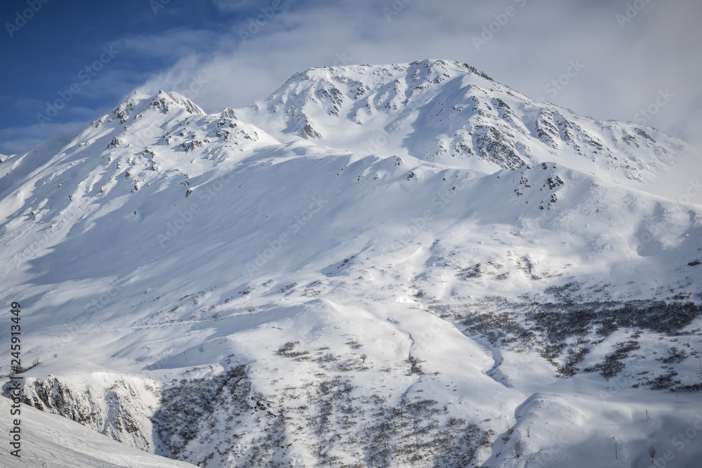Snow covered 2928 meter high Piz Badus near city of Andermatt in central Switzerland