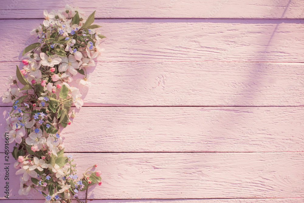Fototapeta premium spring flowers on pink wooden background