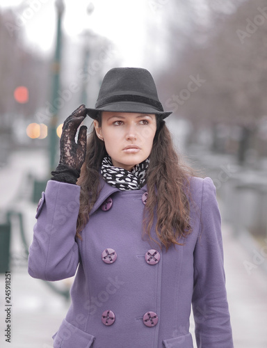 portrait of stylish young woman on city background