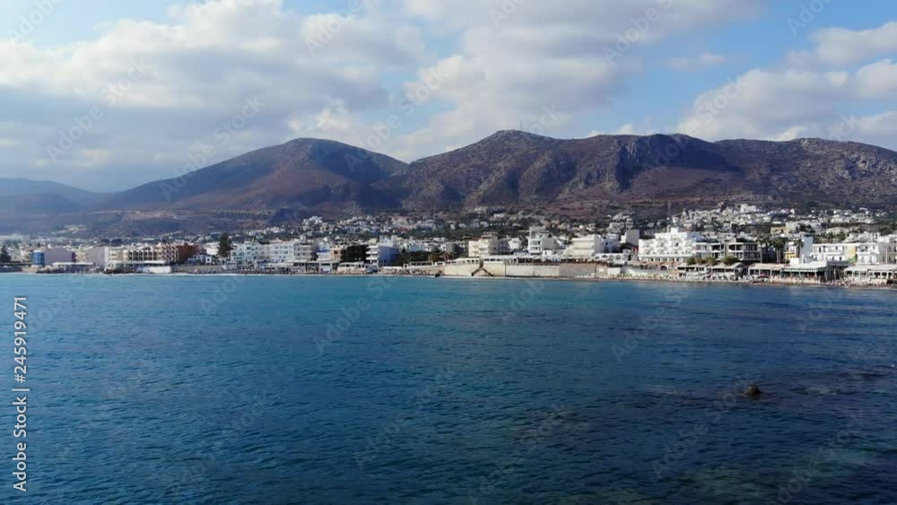 Aerial view on island mountains, white city and blue sea, Crete, Greece Aerial view on island mountains, white city and blue sea, Crete, Greece