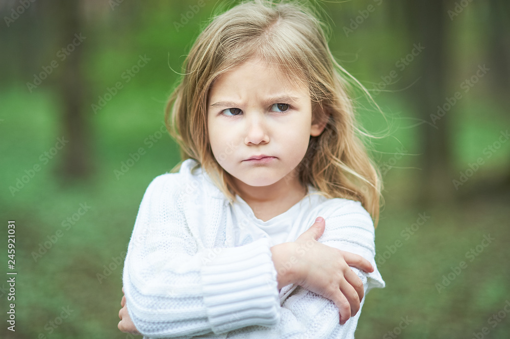 Portrait of sad unhappy little girl. Little sad child is lonesome. upset and distraught angry facial expression. Portrait of sad unhappy little girl. Little sad child is lonesome. upset and distraught angry facial expression.