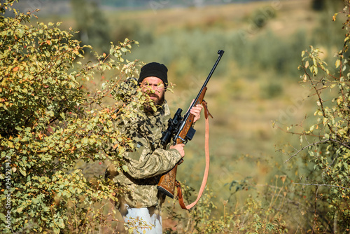 Bearded man hunter. Military uniform fashion. Army forces. Camouflage. Hunting skills and weapon equipment. How turn hunting into hobby. Man hunter with rifle gun. Shoot straight and look great