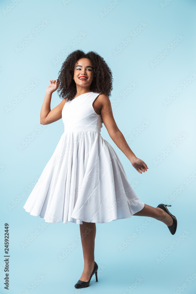 Naklejka premium Full length of a happy african woman wearing dress