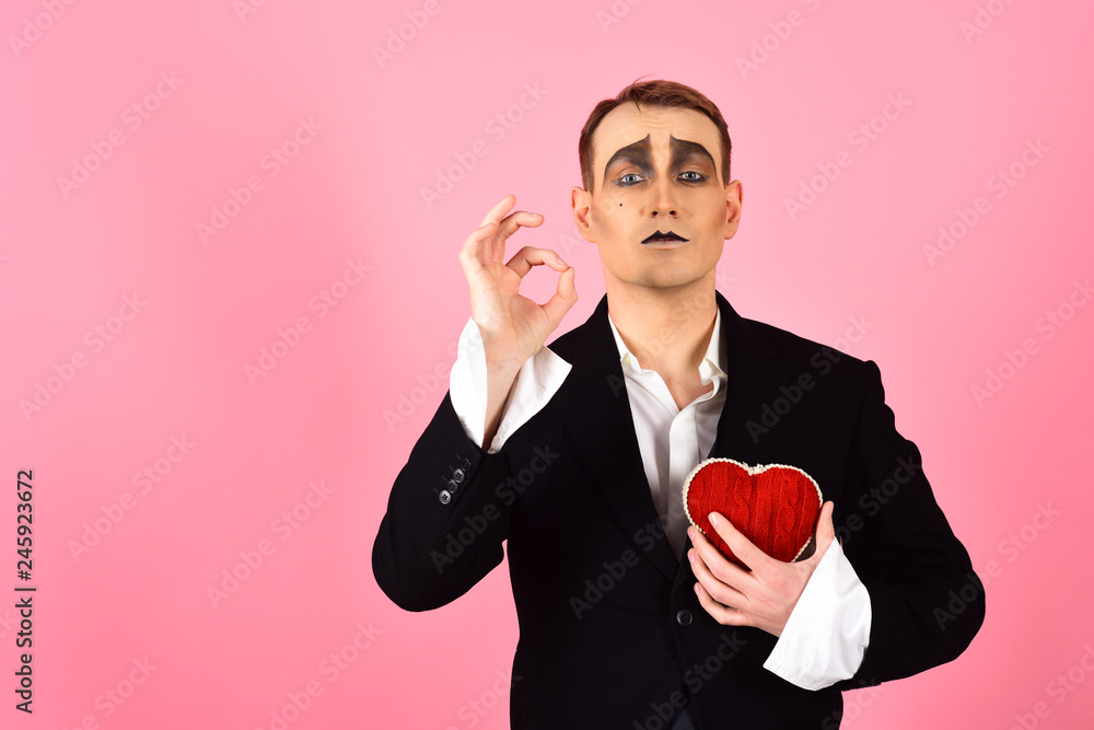 Obsession and romance. Theatre actor pantomime falling in love. Mime man hold red heart for valentines day. Mime actor with love symbol. Love confession on valentines day Obsession and romance. Theatre actor pantomime falling in love. Mime man hold red heart for valentines day. Mime actor with love symbol. Love confession on valentines day