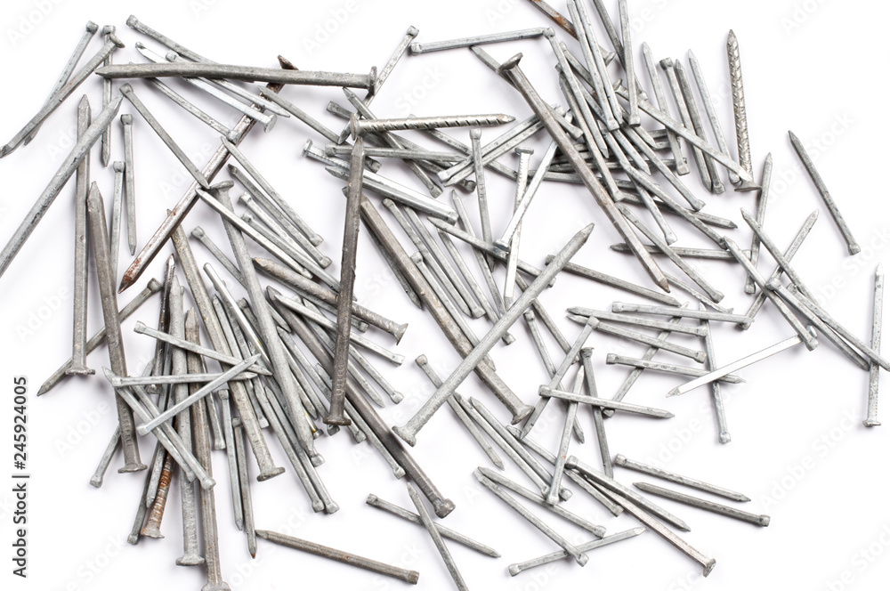 Pile of metal nails on a white background. Pile of metal nails on a white background.
