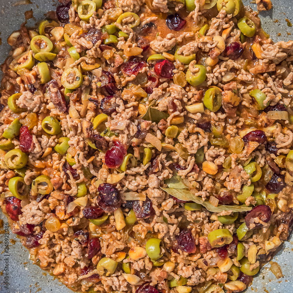 Stuffed with ground meat for Christmas dinner with olives, raisins, cranberries, walnuts, almonds, bay leaf and spices. Homemade traditional food concept Stuffed with ground meat for Christmas dinner with olives, raisins, cranberries, walnuts, almonds, bay leaf and spices. Homemade traditional food concept