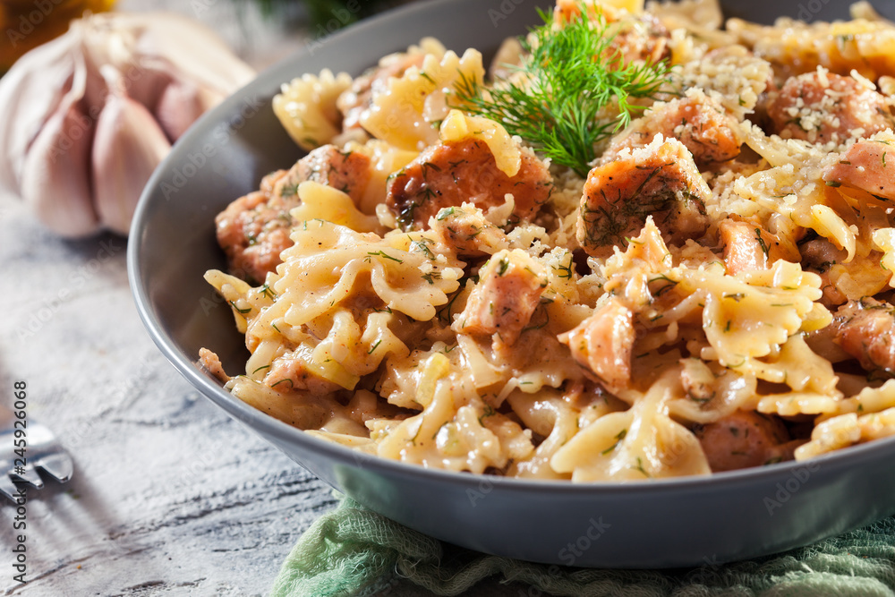 Creamy farfalle pasta with salmon, parmesan cheese and dill Creamy farfalle pasta with salmon, parmesan cheese and dill