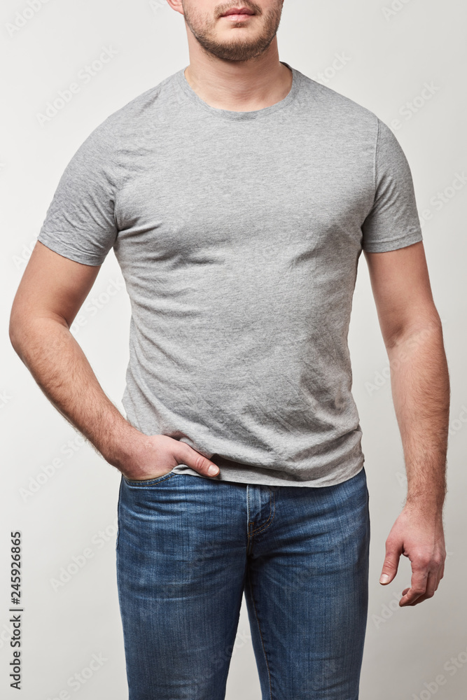 cropped view of man with hand in pocket in t-shirt with copy space isolated on grey cropped view of man with hand in pocket in t-shirt with copy space isolated on grey
