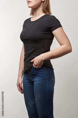 cropped view of young woman in black t-shirt with copy space isolated on white