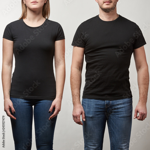 cropped view of young man and woman in black t-shirts with copy space isolated on grey