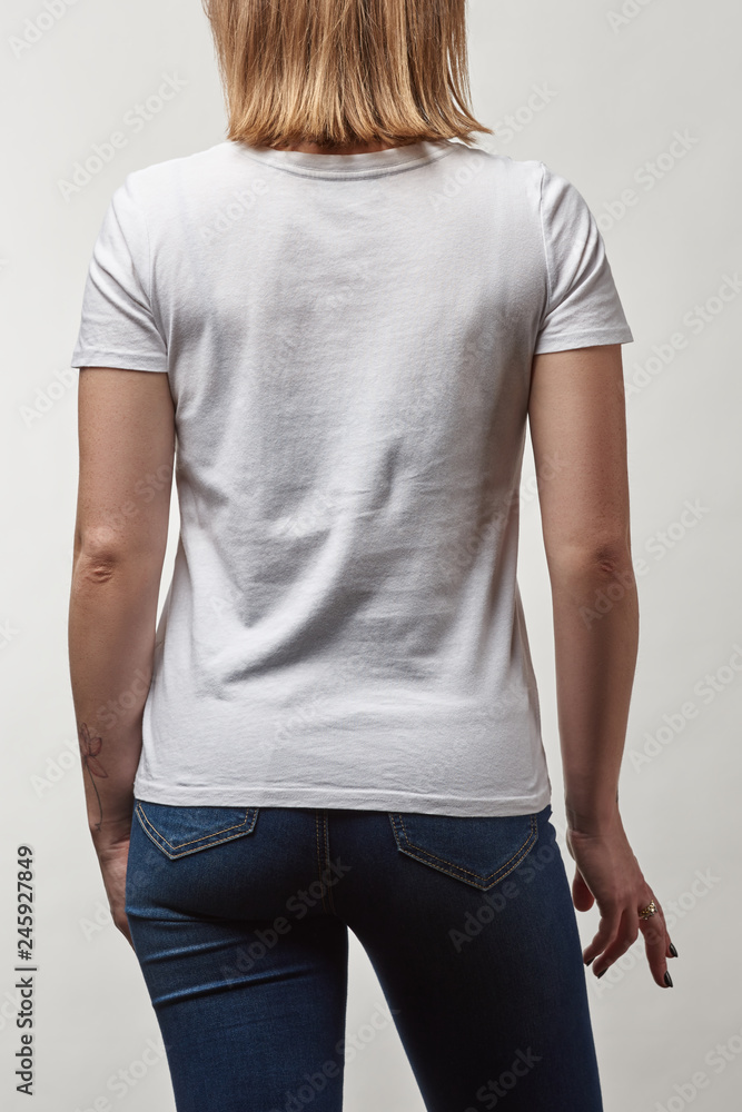 back view of young woman in casual white t-shirt with copy space isolated on white back view of young woman in casual white t-shirt with copy space isolated on white
