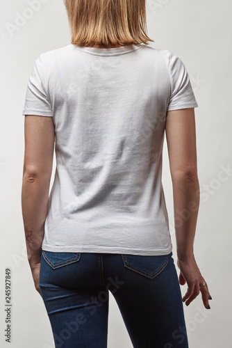 back view of young woman in casual white t-shirt with copy space isolated on white