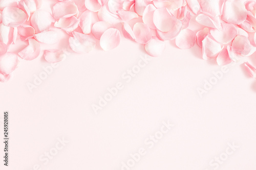 Fototapeta Naklejka Na Ścianę i Meble -  Flowers composition. Rose flower petals on pastel pink background. Valentines day, mothers day, womens day, wedding concept. Flat lay, top view, copy space