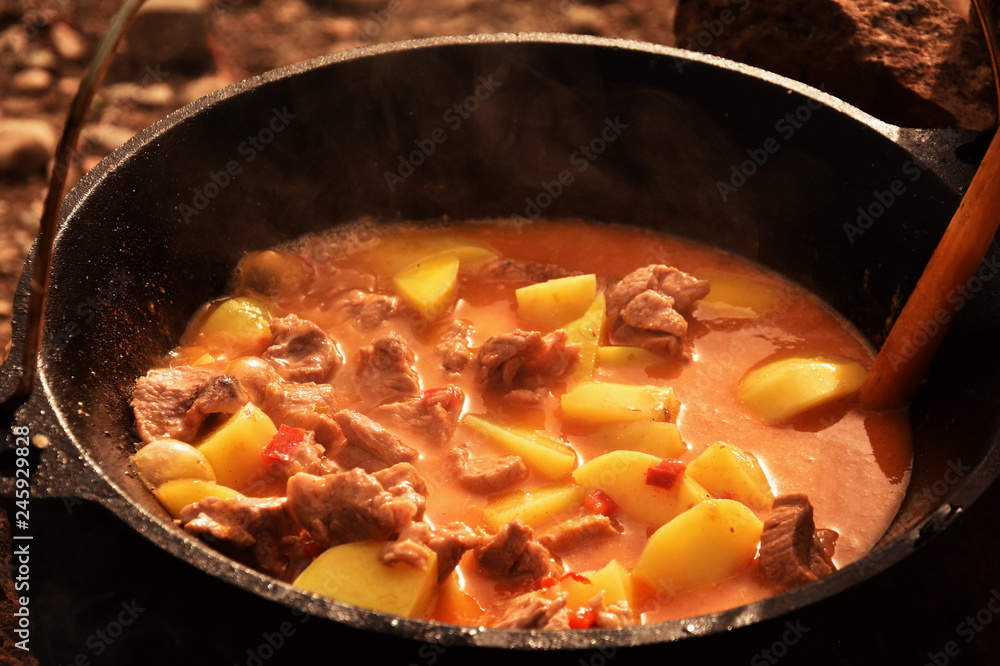 food cooking in stew pot in the nature ,romanian , tocana,traditional ceaun food cooking in stew pot in the nature ,romanian , tocana,traditional ceaun