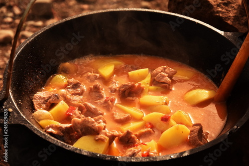 food cooking in stew pot in the nature ,romanian , tocana,traditional ceaun