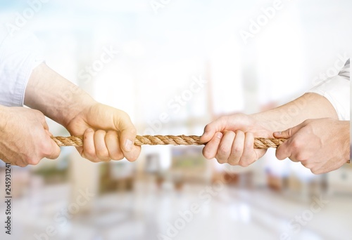 Human hands holding rope from both side isolated on white