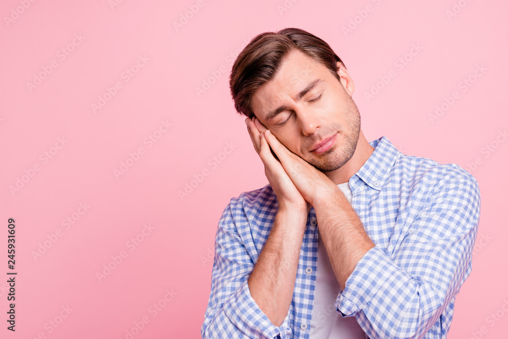 Close-up portrait of his he nice attractive handsome calm guy wearing checked shirt showing sleeping gesture closed eyes isolated over pink pastel background Close-up portrait of his he nice attractive handsome calm guy wearing checked shirt showing sleeping gesture closed eyes isolated over pink pastel background