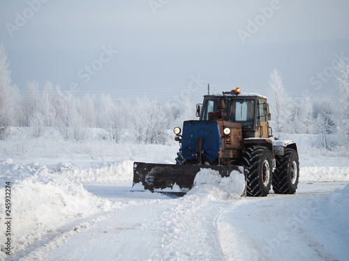 Tver region. Sonkovsky district. Russia. 28 January 2019. Clearing snow from the road. Tractor grader clears snow from the road.