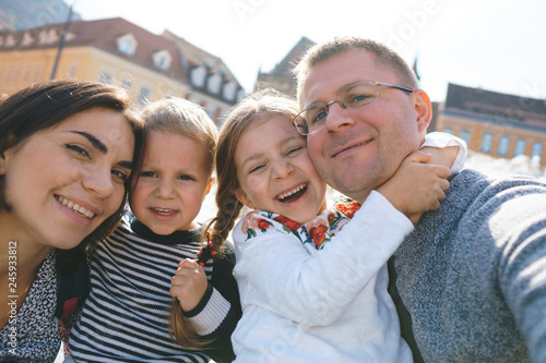laughing family making selfie in city